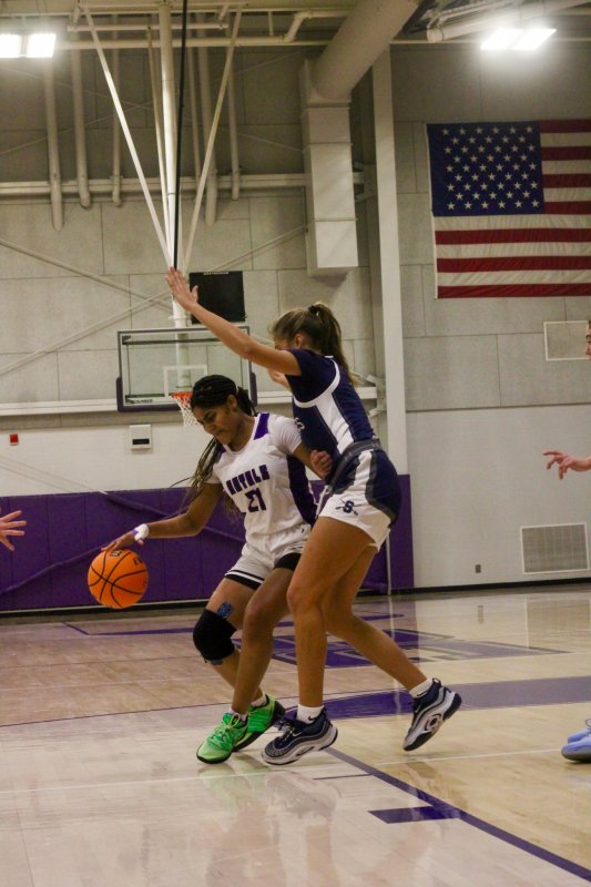 Royals senior Eva Elliott tries to create space as she drives the lane.