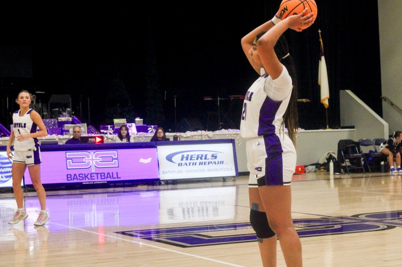 Royals senior Eva Elliott begins to pass the ball.