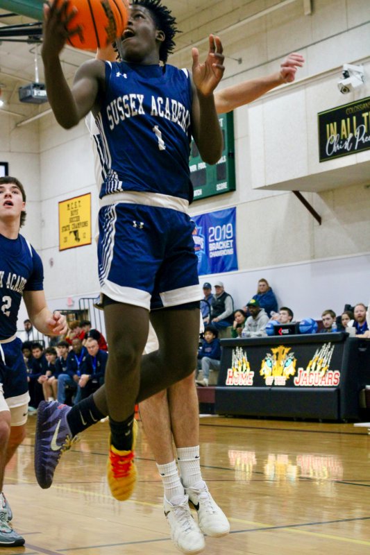 Sussex Academy sophomore Farmar Amisial goes with the underhand scoop.