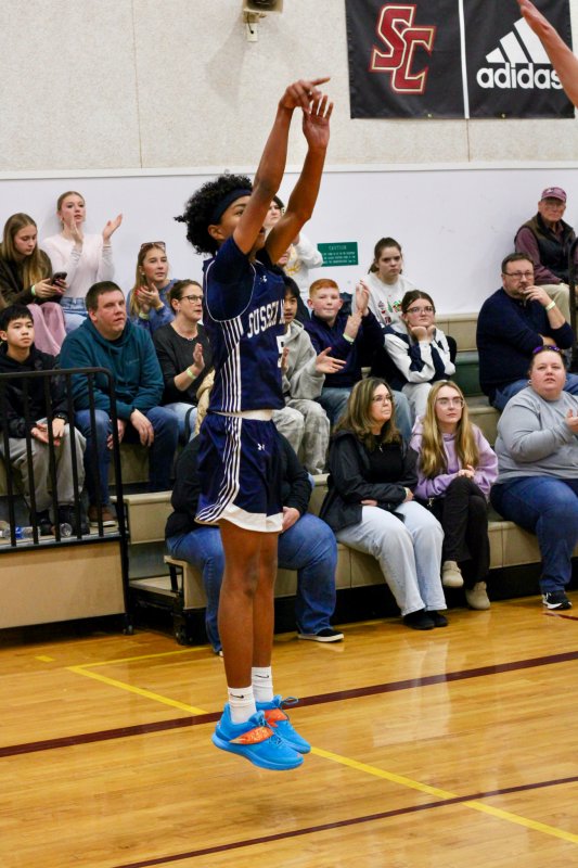 Sussex Academy sophomore Rico Nock keeps the goose neck on this made three-pointer.