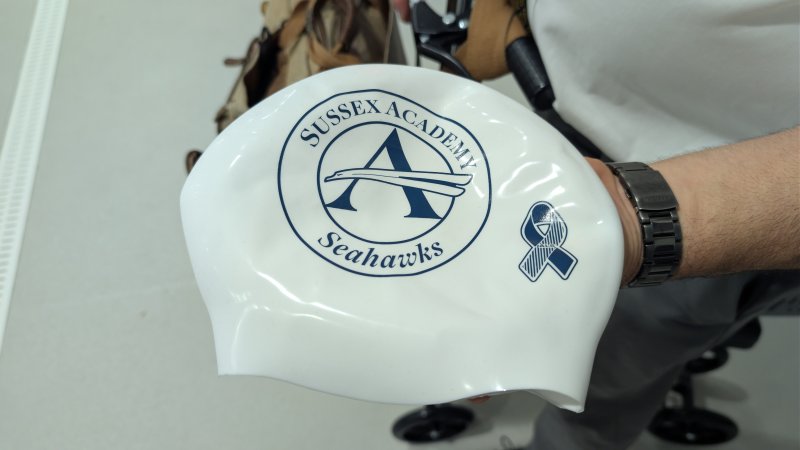 Swimmers took it upon themselves to get new swimming caps with their school logo and the ALS ribbon. Coach Tom Martiner’s brother has been battling ALS for the last five years.