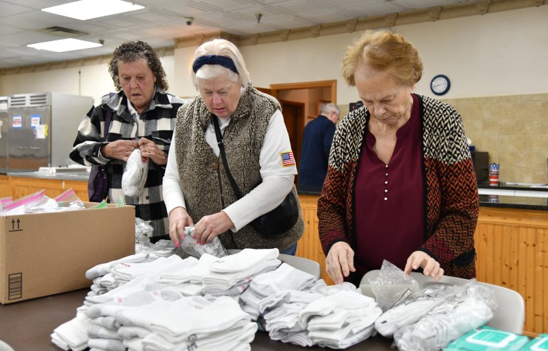 Organizing socks are Auxiliary members (l-r) Judy Tarr, Connie Christopher and Priscilla Horne.