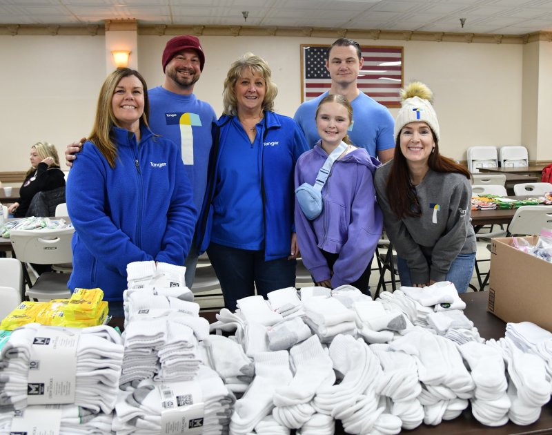 Volunteers from Tanger Outlets brought bags of socks and helped stock the American Legion bags. Shown are (l-r) Michele Doucette, marketing director; Joey Venezia; Jennifer Kayes; Madison North; Anthony Anselmo; and Tanger General Manager Amy Schnerr.