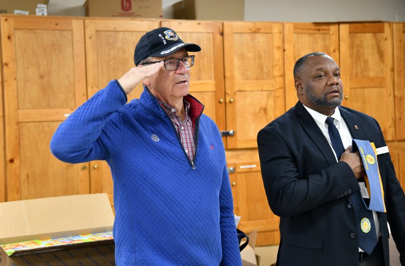 Saluting the flag are Rep. Jeff Hilvosky R-Long Neck, left, and Otas Cephas Jr., Sons of the American Legion Delaware Detachment vice commander.