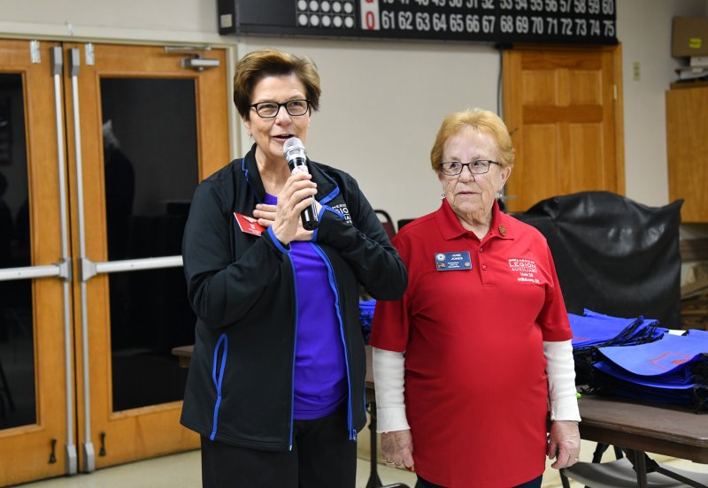 American Legion Auxiliary National President Pam Ray, speaks with the volunteers alongside Unit 28 Auxiliary President June Jones.
