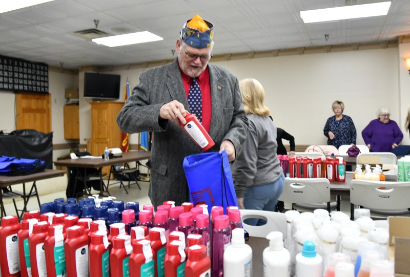 Rick Wheatley, Sons of the American Legion Delaware Detachment commander, helps stock the bags.