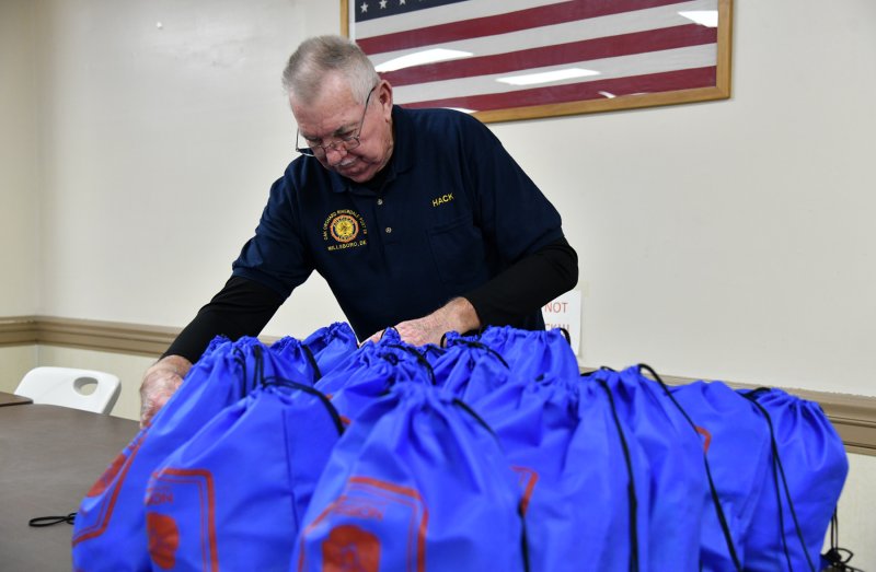Hack Jones, a veteran and member of the AL Post 28 honor guard, stacks up bags as they are filled.