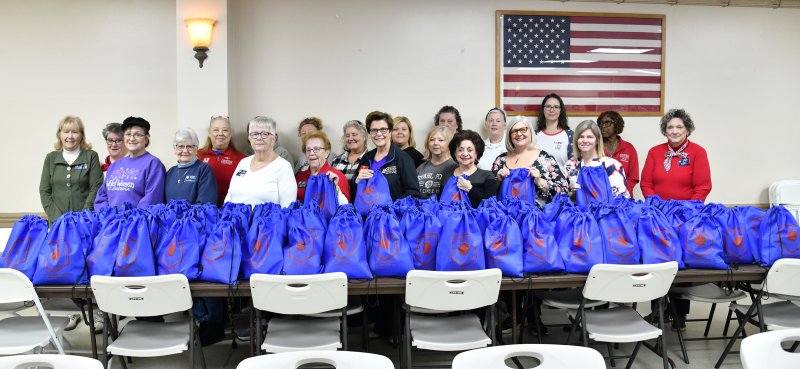 American Legion Auxiliary Unit 28 members stand with the 160 bags packed with items for donation to at-risk veterans at the Wilmington VA Medical Center. DAN COOK PHOTOS