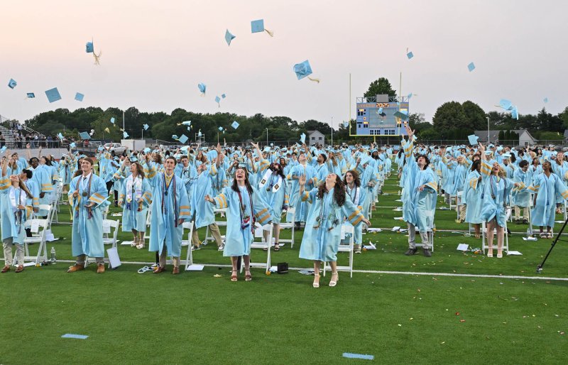 Celebrating graduation, members of the Cape Henlopen High School Class of 2025 toss their academic caps into the air. DAN COOK PHOTO