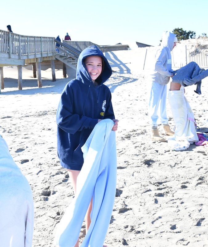 Mia Watts is happy to get into a warm sweatsuit after the plunge.