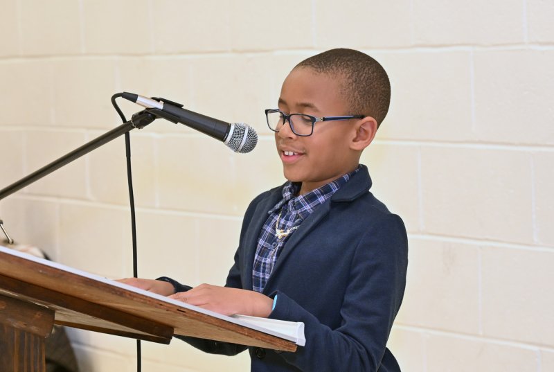 Rehoboth Elementary School student Wayne Christian Hall gives a reading during the ceremony.