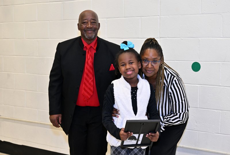 Reader Mia Hall gets a certificate of appreciation from Clem Jordan, president of the Dr. Martin Luther King Jr. Celebration Organization Sussex County Inc., left, and member Katina Gooch.