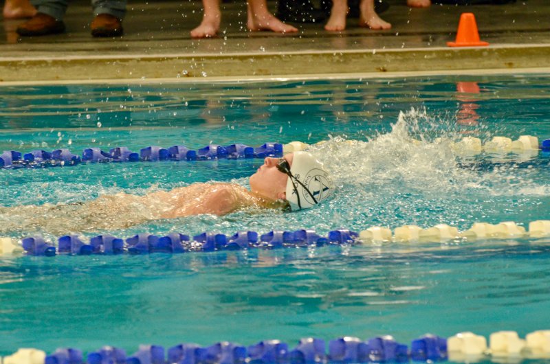 Sussex Academy freshman Kaleb Siok splashes back.