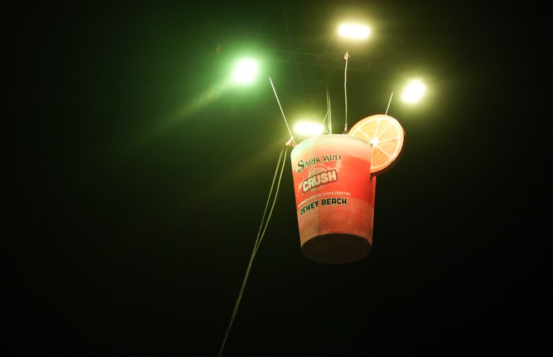 A giant Orange Crush cup hangs above the town ahead of the Crush Drop.