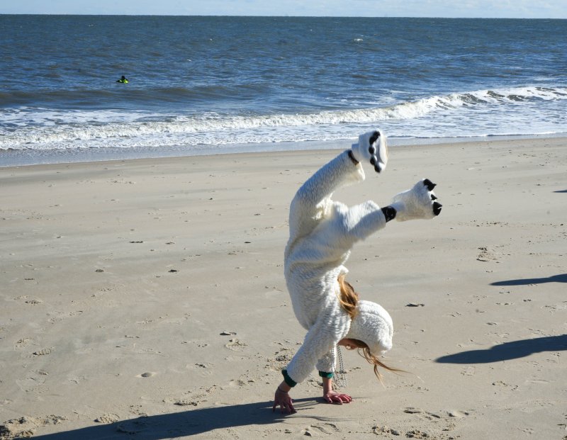 Ava Usefara does some gymnastics on the beach before the dunk.