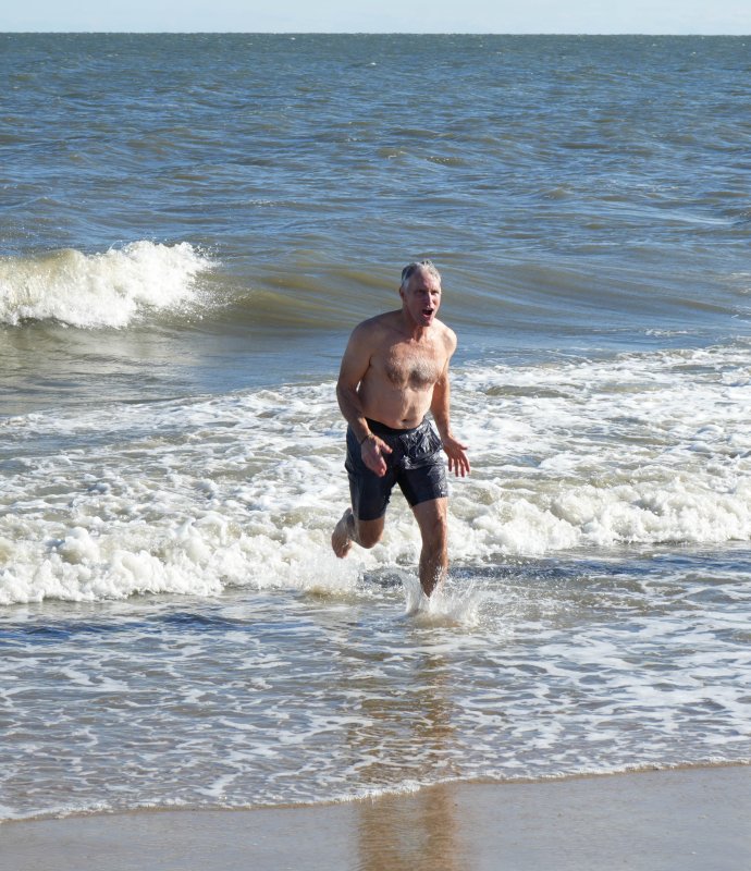 Darrell Helms runs out of the water.