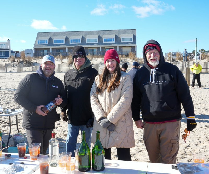 Dewey Business Partnership volunteers serve up bloody marys and mimosas. Shown are (l-r) Rich Godbout, David Cohen, Kelsey Murphy and Erik Sweterlitsch.