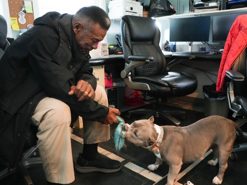 Don Robinson, the DBPD’s court liaison, plays tug-of-war with Lola during a free moment at the office. Robinson brings in a Chick-fil-A biscuit every morning to split with Lola.