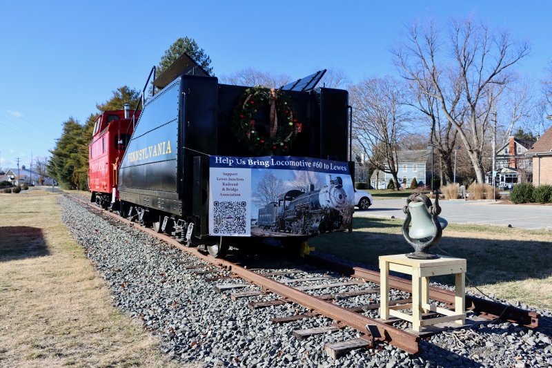 The LJRBA’s tender and red caboose will be pushed farther west down the track to accommodate engine No. 60. The engine’s headlight will face east, toward the beach. The banner shows the locomotive with the bell attached on the top, near the cab.