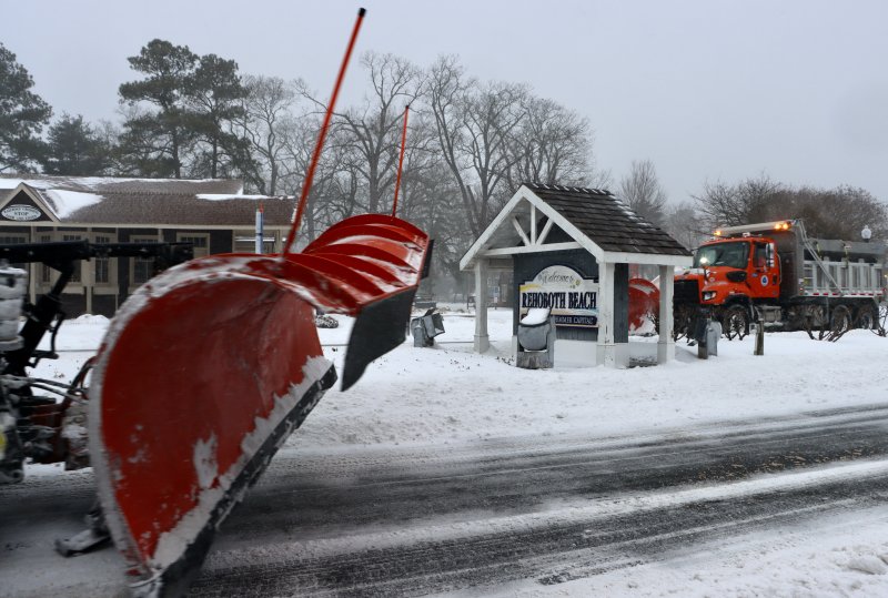 Two DelDOT plows pass near the circle in Rehoboth Beach. BILL SHULL PHOTO