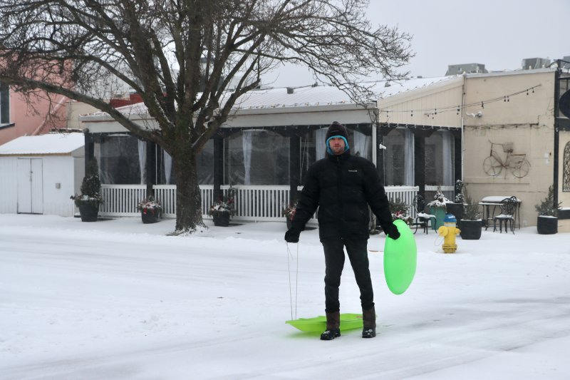 Thomas Blades was on his way to sled on the hill in Lake Gerar Park in Rehoboth Beach. BILL SHULL PHOTO
