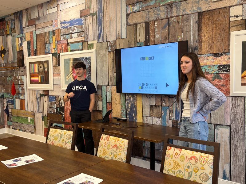Cape Henlopen High School DECA student representatives share a tutorial on how to play New York Times games with residents of The Lodge at Historic Lewes. Shown are Sullivan Naden, left, DECA vice president, and Addison Breneman, DECA president. SUBMITTED PHOTOS