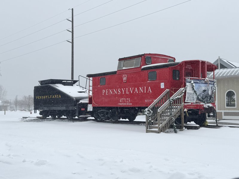 The caboose and coal tender next to the Lewes library pop in the white snow. NICK ROTH PHOTO