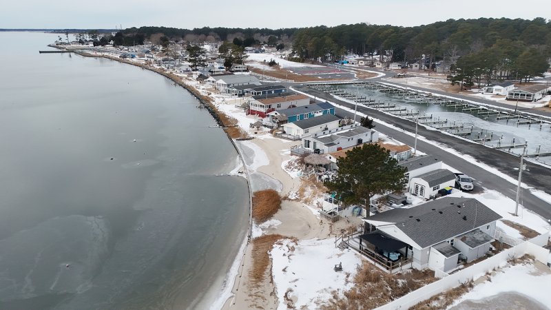 Homes along White House Beach on frozen the Indian River Bay.