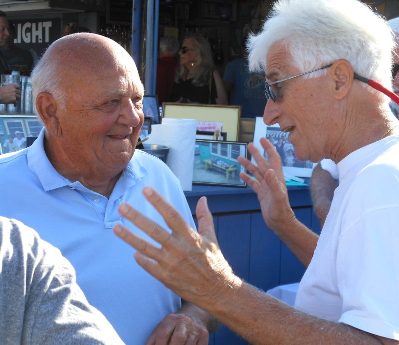 Ed Riggin, left, and Jim Dedes, Dewey assistant town manager, share some memories at the Starboard during the appreciation event for Riggin and Ed’s Chicken and Crabs.