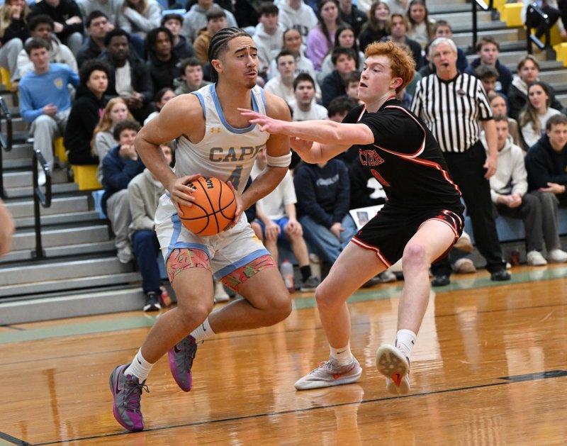 Jameson Tingle drives baseline on Polytech’s Jackson Arndt. DAN COOK PHOTO