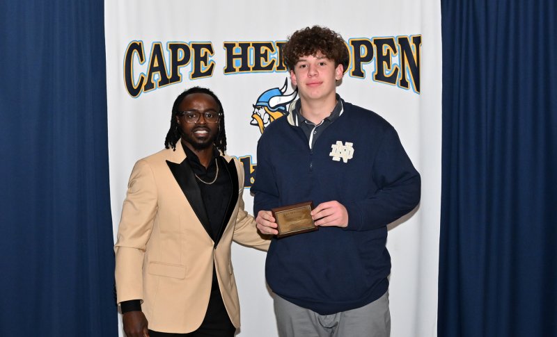 Cape freshman coach Terrique Riddick presents the freshman Sportsmanship Award to Mark Lally.