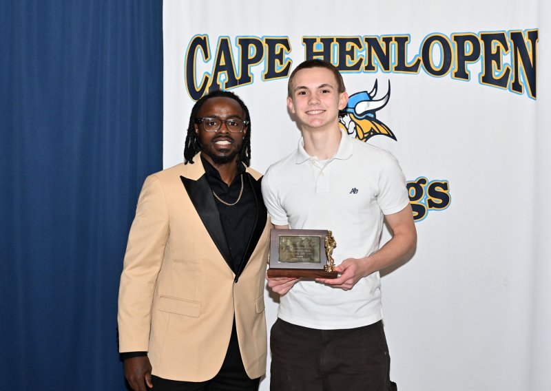 Cape freshman coach Terrique Riddick presents the Freshman MVP Award to Grayson Lehmuth.