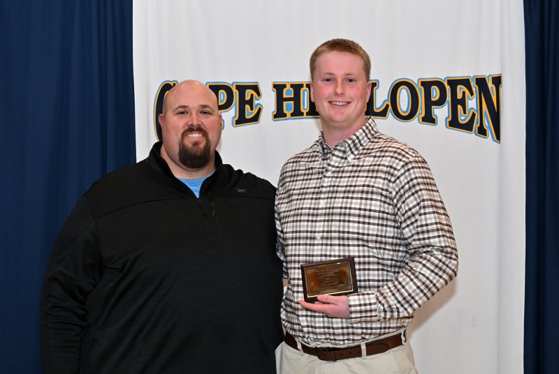 Offensive line coach Mike Tesno presents the Varsity Sportsmanship Award to senior Liam Ramsey.