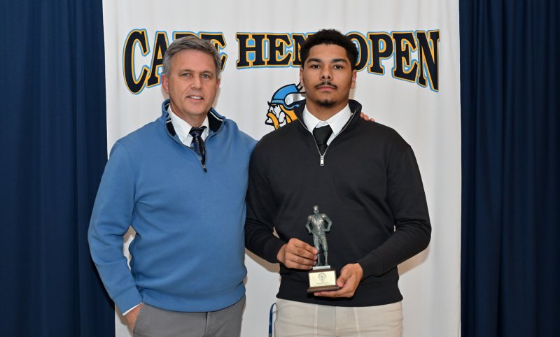 Head coach Chip Knapp presents the Maxwell Football Club Award to senior Dell Richards.