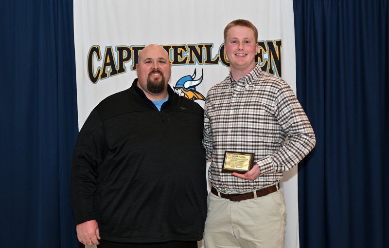 Offensive line coach Mike Tesno presents the Offensive Lineman of the Year Award to senior Liam Ramsey.