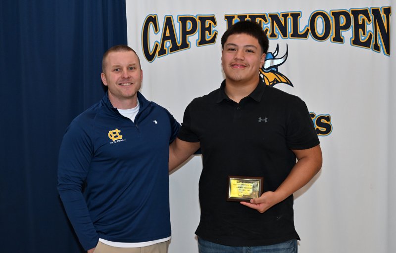 Varsity coach Jason Hunt presents the Defensive Lineman of the Year Award to Javier Morales. Morales had four sacks in 2025.