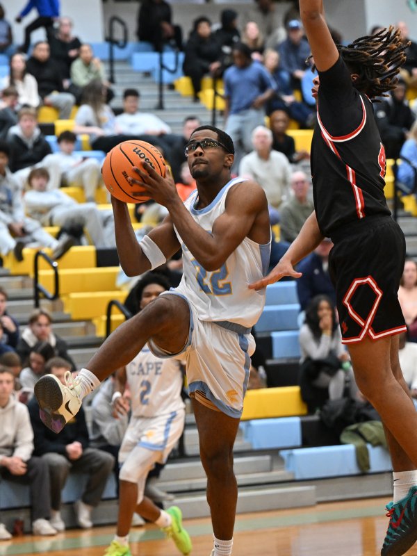 Oz Batson goes in strong against Polytech’s Haleem Edwards. DAN COOK PHOTO.