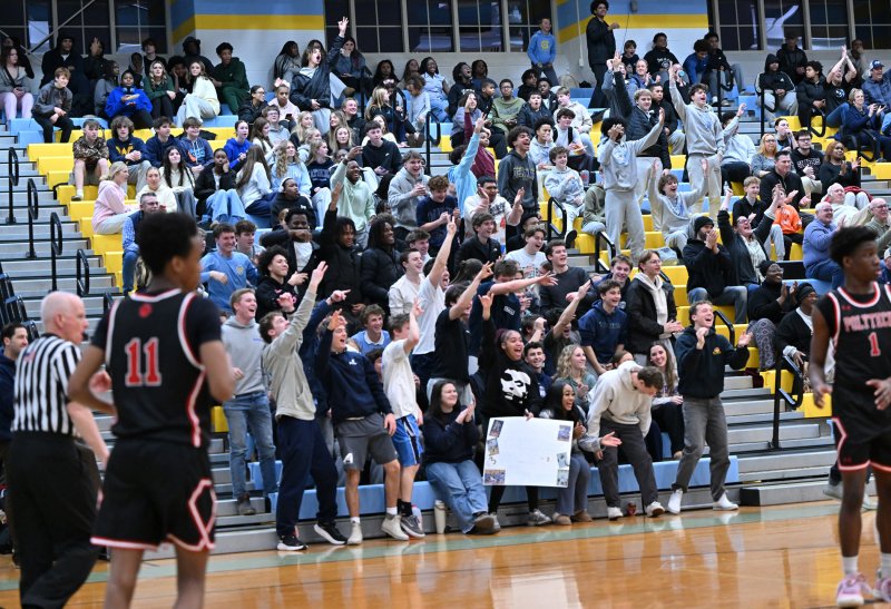 The Cape student section goes wild over a made three. DAN COOK PHOTO