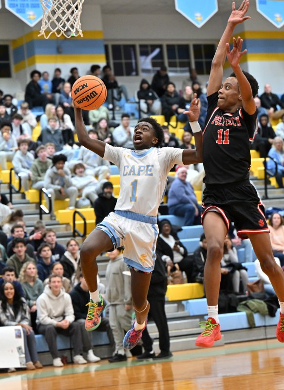 Stephen Sivels goes in strong against Poly’s Sakhi Anderson for two of his 17 points. DAN COOK PHOTO
