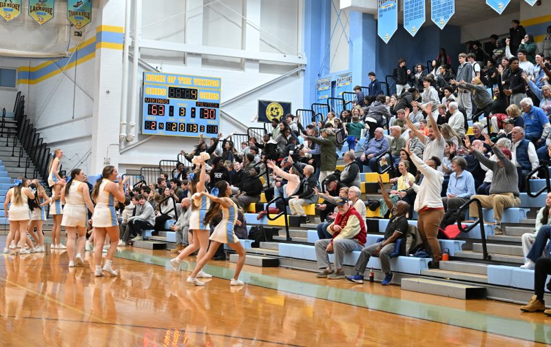 The Cape cheerleaders hurl T-shirts into the crowd. DAN COOK PHOTO