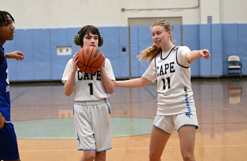 Cape sophomore Harlan Jones gets an assist from unified partner Grace Heers.