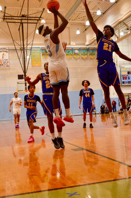 Cape senior David Barnes shoots over the outstretched hand of Tristen Bell. AARON R. MUSHRUSH PHOTO