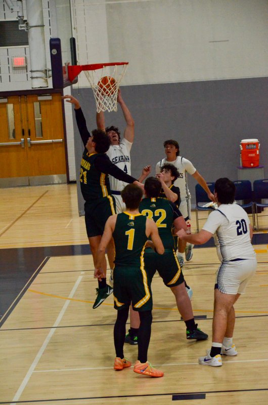 Sussex Academy sophomore Ben Tollett pulls in a rebound.