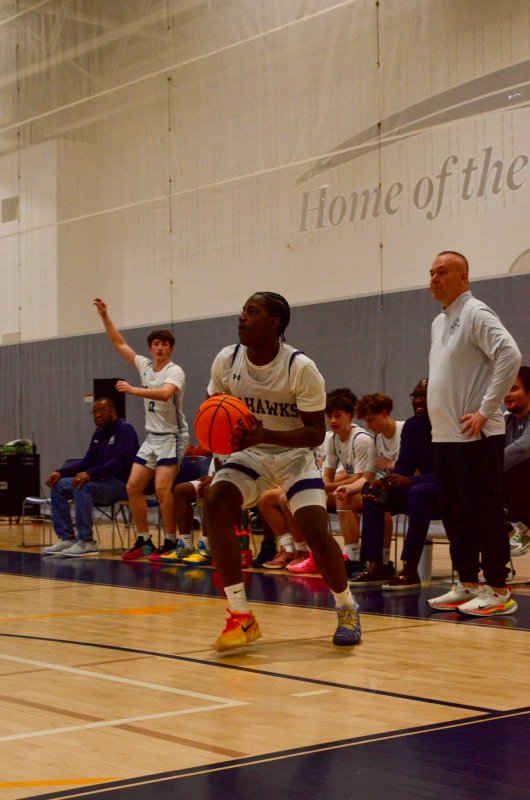 Sussex Academy senior Tate Sickler knows sophomore Farmar Amisial is about to knock down this pump fake three.