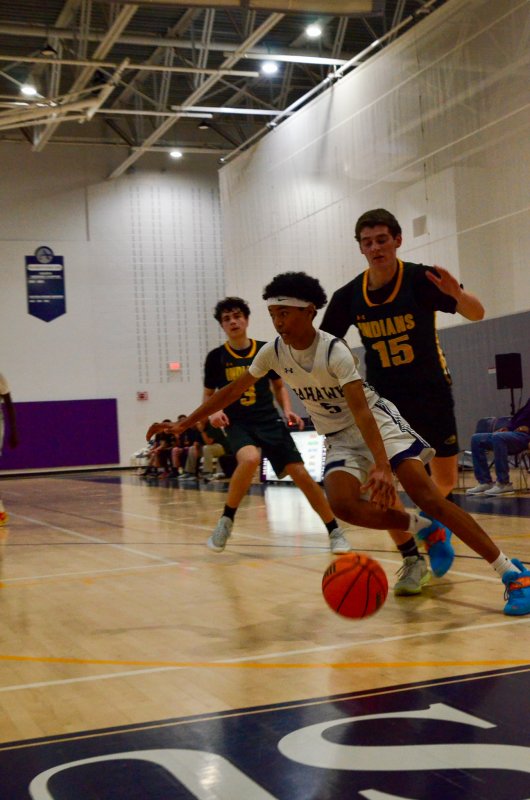 Sussex Academy sophomore Rico Nock drives the baseline.