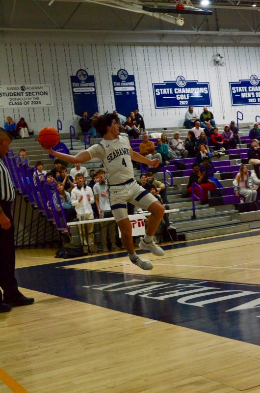 Sussex Academy third baseman Ben Tollett jumps up to save a base hit to the hot corner er I mean Tollett saves the ball in basketball.