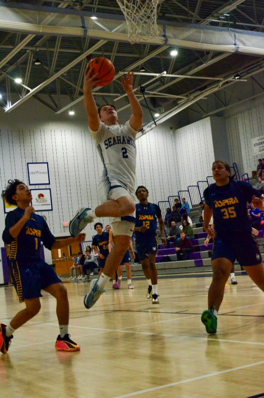 Sussex Academy sophomore Mason Glover finishes at the rim.