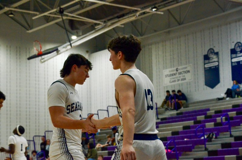 Sussex Academy senior Tate Sickler, right, is congratulated by Mason Glover.