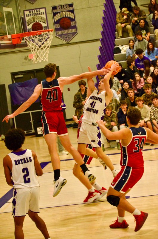 Royals sophomore Asher Woods avoids the block.