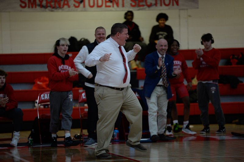 Smyrna coach Kent Robinson celebrates a win at 126.